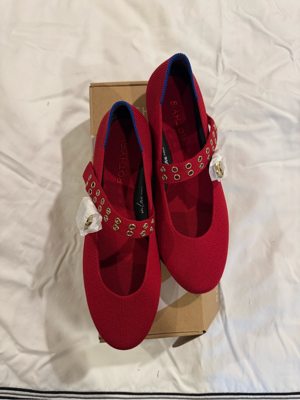 Box of shoes on bed